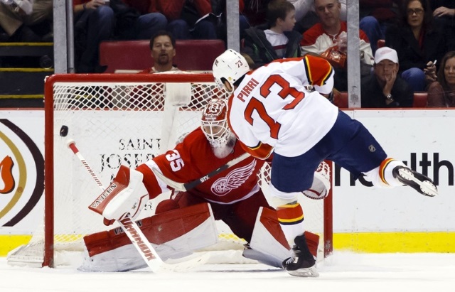 Jimmy Howard of the Detroit Red Wings and Brandon Pirri of the Florida Panthers