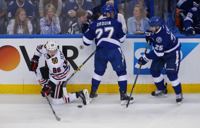 Jonathan Drouin and Matt Carle of the Tampa Bay Lightning, Teuvo Teravainen of the Chicago Blackhawks