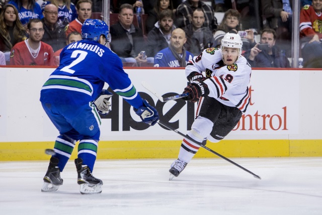 Dan Hamhuis of the Vancouver Canucks and Jonathan Toews of the Chicago Blackhawks