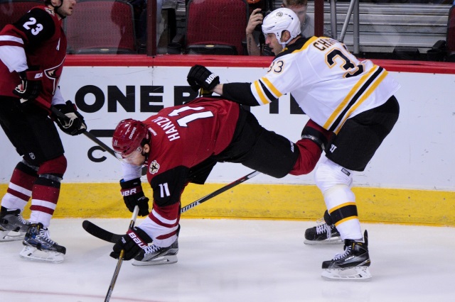 Zdeno Chara of the Boston Bruins and Martin Hanzal of the Arizona Coyotes