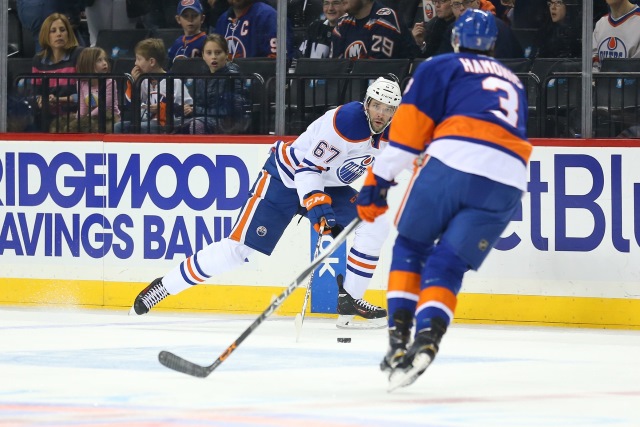 Benoit Pouliot of the Edmonton Oilers and Travis Hamonic of the NY Islanders