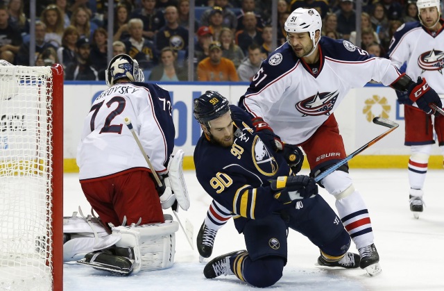 Fedor Tyutin of the Columbus Blue Jackets and Ryan O'Reilly of the Buffalo Sabres