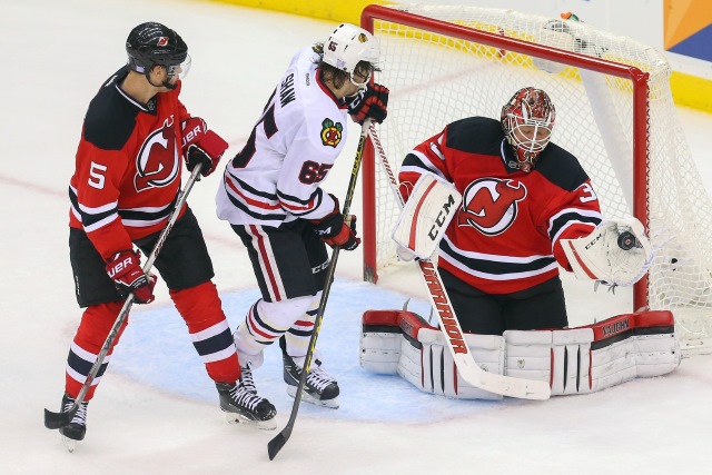 Andrew Shaw of the Chicago Blackhawks and Corey Schneider of the New Jersey Devils