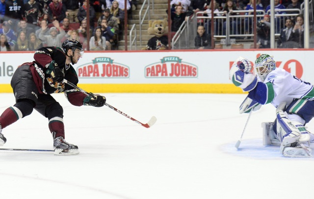 Tobias Rieder of the Arizona Coyotes and Eddie Lack then of the Vancouver Canucks