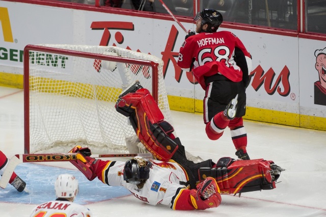 Mike Hoffman of the Ottawa Senators and Jonas Hiller of the Calgary Flames