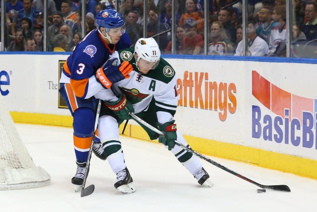 Zach Parise of the Minnesota Wild and Travis Hamonic of the NY Islanders