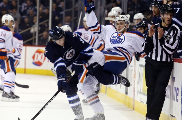 Jacob Trouba of the Winnipeg Jets and Jason Williams of the Edmonton Oilers