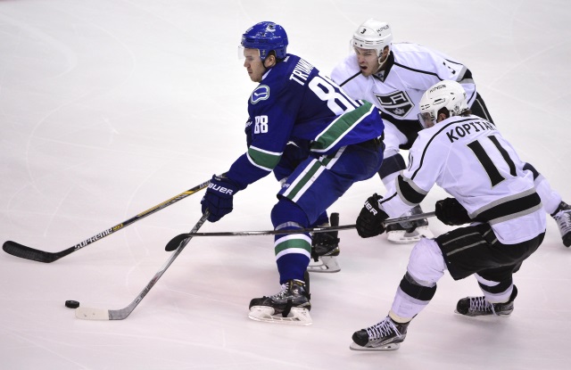 Nikita Tryamkin of the Vancouver Canucks and Brayden McNabb of the Los Angeles Kings