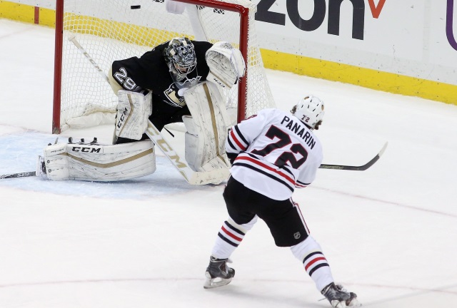 Chicago Blackhawks Artemi Panarin scoring on Pittsburgh Penguins goalie Marc-Andre Fleury