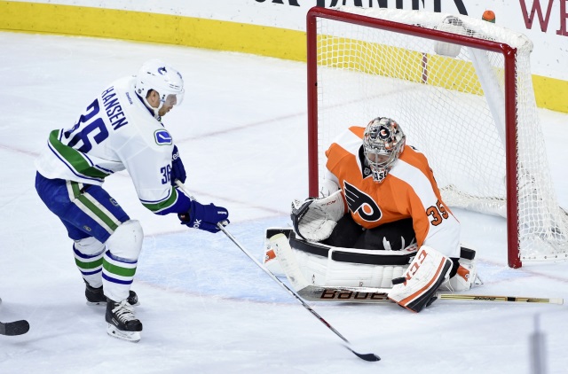 Steve Mason of the Phildalephia Flyers and Jannik Hansen of the Vancouver Canucks