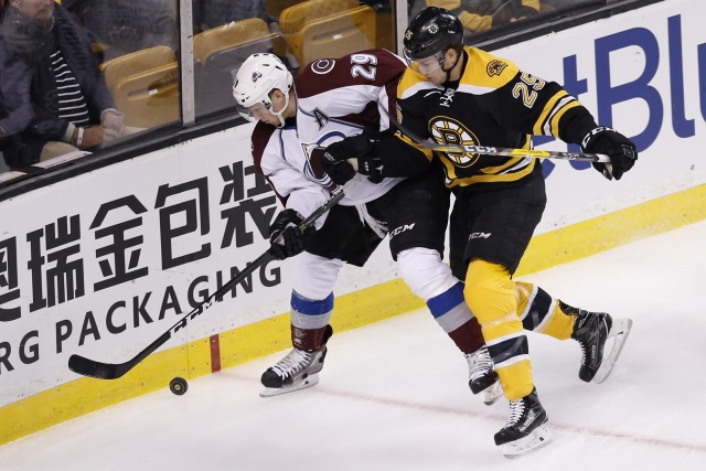 Nathan MacKinnon of the Colorado Avalanche and Brandon Carlo of the Boston Bruins