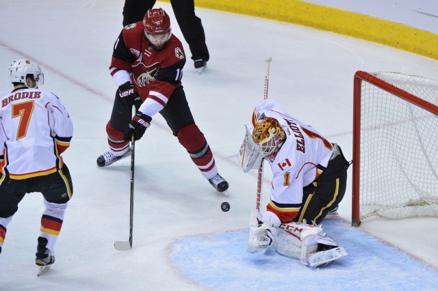 Martin Hanzal of the Arizona Coytoes and Brian Elliott of the Calgary Flames