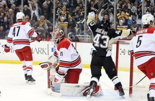 Eddie Lack of the Carolina Hurricanes and Conor Sheary of the Pittsburgh Penguins