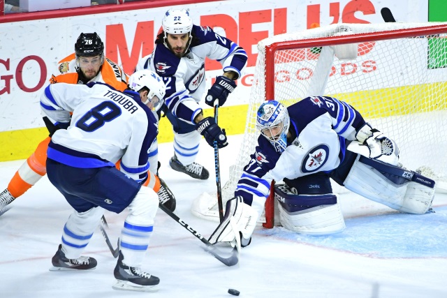 Connor Hellebuyck and Jacob Trouba of the Winnipeg Jets