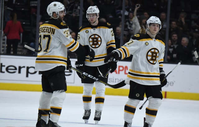 Patrice Bergeron, Brandon Carlo and Torey Krug of the Boston Bruins