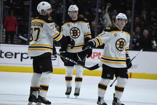 Torey Krug, Brandon Carlo and Patrice Bergeron of the Boston Bruins