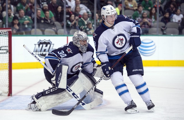 Jacob Trouba and Connor Hellebuyck of the Winnipeg Jets