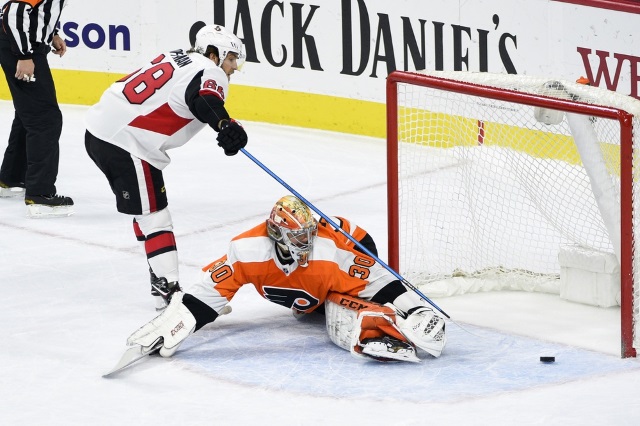 Mike Hoffman of the Ottawa Senators and Michal Neuvirth of the Philadelphia Flyers