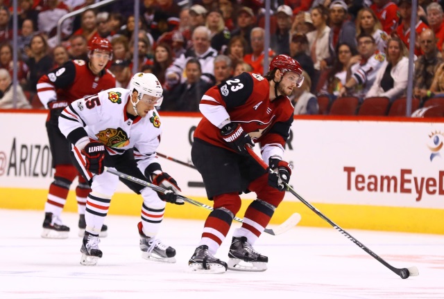 Oliver Ekman-Larsson of the Arizona Coyotes and Artem Anisimov of the Chicago Blackhawks