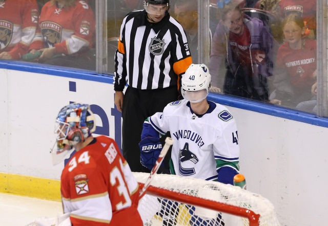 Vancouver Canucks Elias Pettersson leaves after being thrown to the ice.