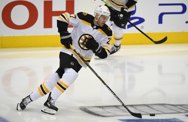 Boston Bruins defenseman John Moore isn't playing at a 100 percent