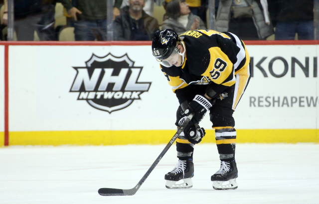 Penguins Jake Guentzel crashes awkwardly into the boards.