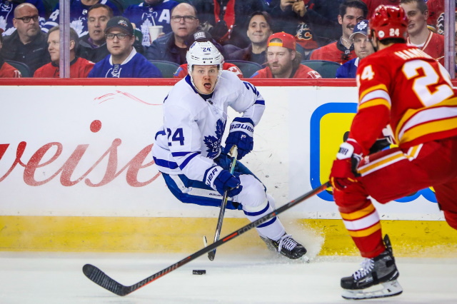 Kasperi Kapanen of the Toronto Maple Leafs and Travis Hamonic of the Calgary Flames