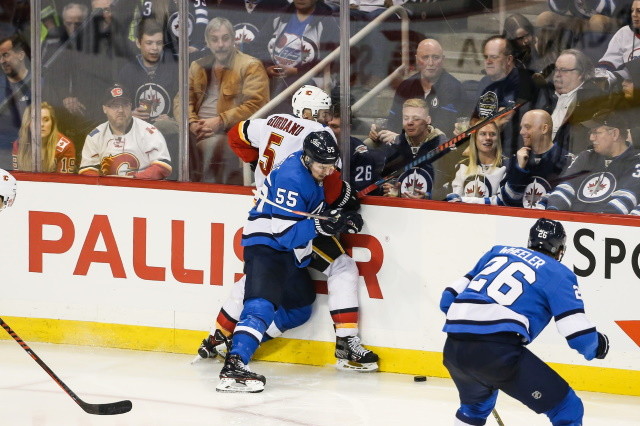 Mark Scheifele of the Winnipeg Jets and Mark Giordano of the Calgary Flames