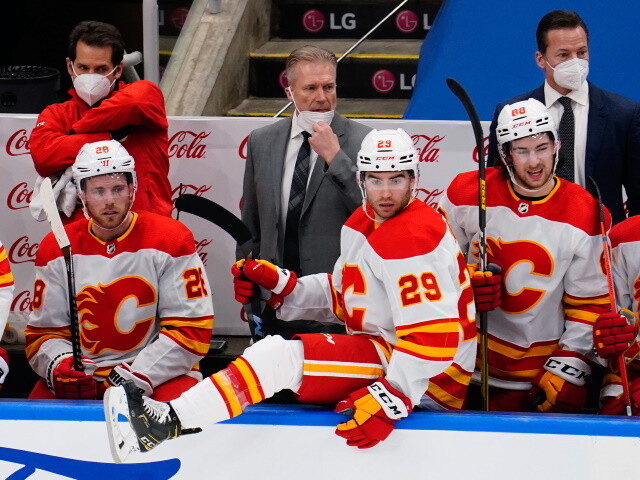 Aho and Jarvis enter protocol. Bozak and Faulk exit protocol. Six Calgary Flames test positive and have three games postponed.